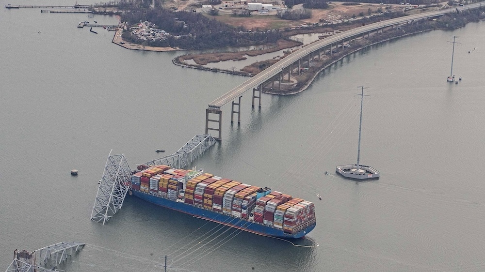 The container ship Dali is shown amidst the wreckage of the collapsed Francis Scott Key Bridge in Baltimore, Tuesday, March 26, 2024. Six people are missing after the Dali lost power and crashed into one of the bridge's support columns.